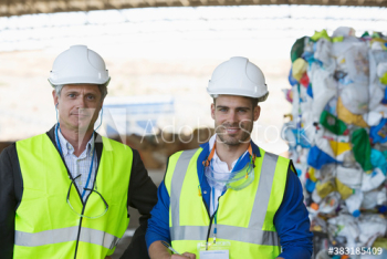 Portrait confident male workers in recycling plant Portrait confident male workers in recycling plant