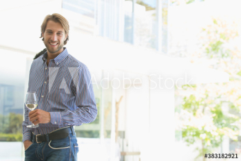 Portrait confident young man drinking white wine Portrait confident young man drinking white wine
