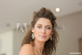 Portrait confident young woman with curly hair Portrait confident young woman with curly hair
