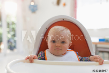 Portrait cute baby girl in high chair Portrait cute baby girl in high chair