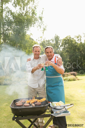 Portrait father and adult son barbecuing and enjoying cocktails Portrait father and adult son barbecuing and enjoying cocktails