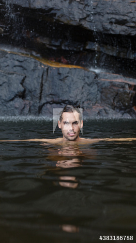 Portrait handsome young man swimming in lake