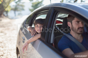 Portrait happy boy leaning out car window Portrait happy boy leaning out car window
