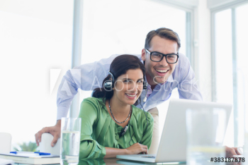 Portrait happy business people using laptop Portrait happy business people using laptop