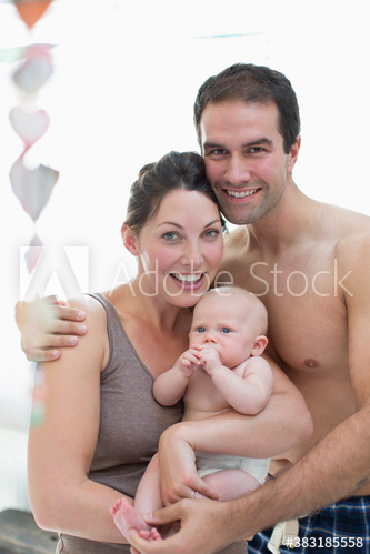 Portrait happy couple with baby daughter Portrait happy couple with baby daughter