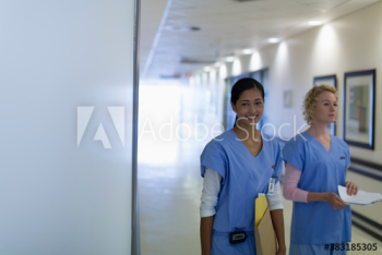 Portrait happy female nurses in hospital corridor Portrait happy female nurses in hospital corridor