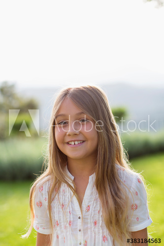 Portrait happy girl in sunny backyard Portrait happy girl in sunny backyard