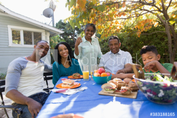 Portrait happy multi-generation family enjoying lunch on autumn patio Portrait happy multi-generation family enjoying lunch on autumn patio