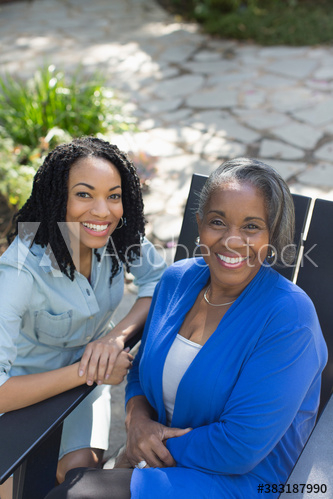 Portrait happy senior mother and adult daughter on patio Portrait happy senior mother and adult daughter on patio