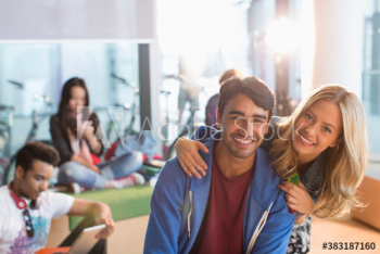 Portrait happy young couple in college student lounge Portrait happy young couple in college student lounge
