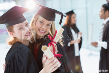 Portrait happy young female college students graduating Portrait happy young female college students graduating