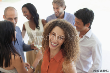 Portrait happy young woman enjoying social gathering with friends