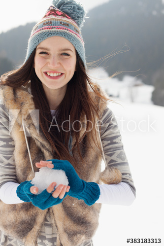 Portrait happy young woman making snowball Portrait happy young woman making snowball
