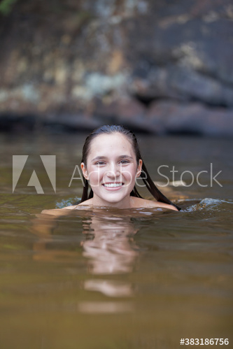 Portrait happy young woman swimming in lake Portrait happy young woman swimming in lake