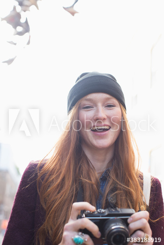 Portrait happy young woman with camera Portrait happy young woman with camera