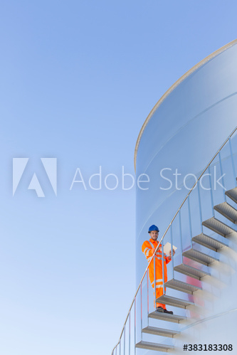 Portrait male worker on storage tank stairs Portrait male worker on storage tank stairs