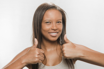 Portrait of a happy teenage girl gesturing thumbs up Portrait of a happy teenage girl gesturing thumbs up