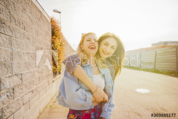 Portrait of smiling women standing on street Portrait of smiling women standing on street
