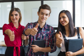 Portrait of successful young students showing thumbs up Portrait of successful young students showing thumbs up