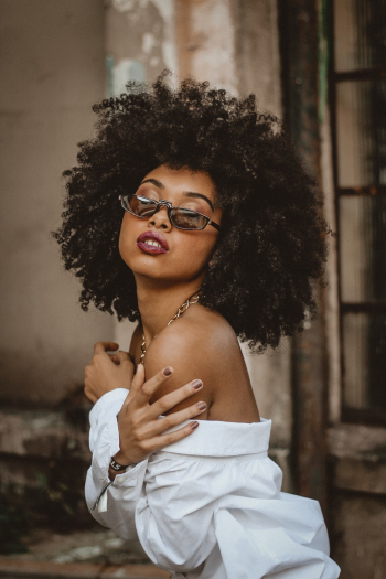 Portrait of Woman with Curly Hair and Sunglasses Portrait of Woman with Curly Hair and Sunglasses