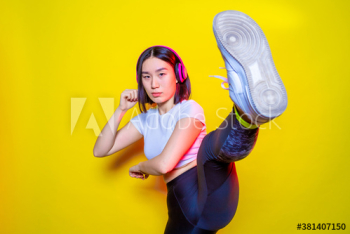 Portrait of young woman practicing kickboxing indoors Portrait of young woman practicing kickboxing indoors
