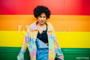 Portrait of young woman standing by wall Portrait of young woman standing by wall
