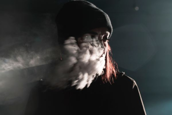 portrait photography of person blowing smoke portrait photography of person blowing smoke