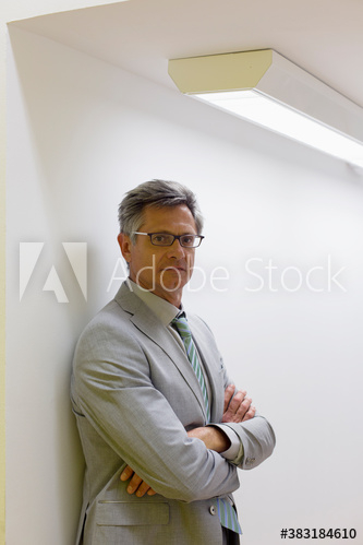 Portrait serious mature corporate businessman with arms crossed Portrait serious mature corporate businessman with arms crossed
