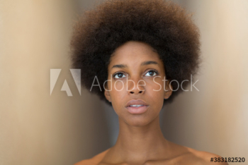 Portrait serious young woman with afro looking up Portrait serious young woman with afro looking up
