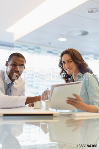 Portrait smiling business people discussing paperwork Portrait smiling business people discussing paperwork