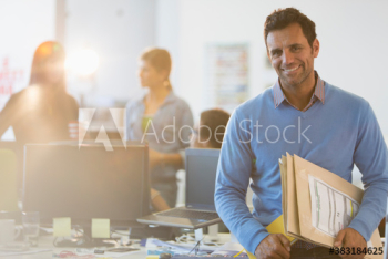 Portrait smiling businessman in office Portrait smiling businessman in office