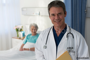 Portrait smiling doctor checking on senior patient in hospital room Portrait smiling doctor checking on senior patient in hospital room