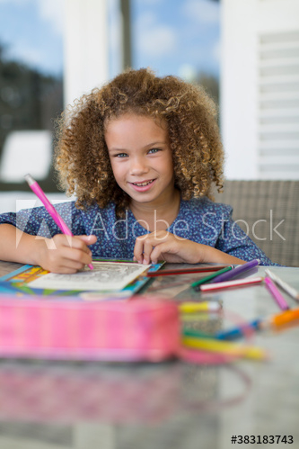 Portrait smiling girl coloring at table Portrait smiling girl coloring at table