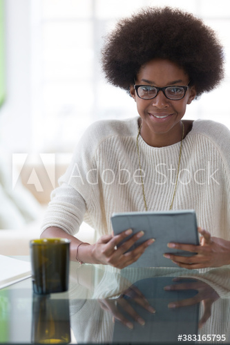 Portrait smiling young woman with afro using digital tablet Portrait smiling young woman with afro using digital tablet