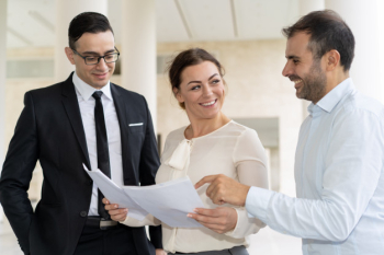 Positive business team working with papers Positive business team working with papers