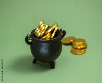 pot with leprechaun gold on a green background. St. patrick's day concept