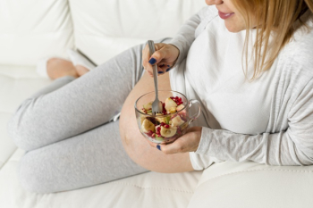 Pregnant lady eating a salad Free Photo