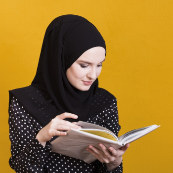 Pretty arab woman reading textbook over bright yellow background Free Photo
