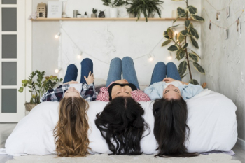 Pretty females lying on bed Free Photo Pretty females lying on bed Free Photo