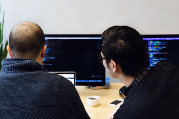 Programmers Reviewing Code On Computer Programmers Reviewing Code On Computer