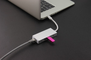 Purple Flash Drive Near Laptop Computer Purple Flash Drive Near Laptop Computer