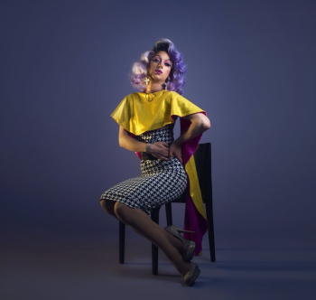 Purple Haired Drag Queen Poses In Chair Purple Haired Drag Queen Poses In Chair