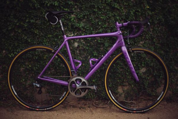 purple road bike near wall purple road bike near wall