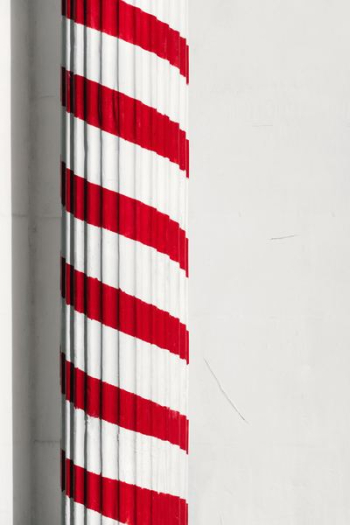red and white painted pedestal column red and white painted pedestal column