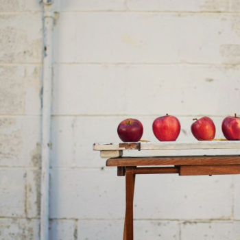 red apples on white wooden board red apples on white wooden board