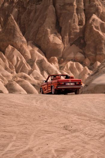 Red Cabrio Car Driving in the Desert Red Cabrio Car Driving in the Desert