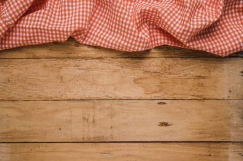 Red checkered table cloth at the top of old wooden worktop Free Photo