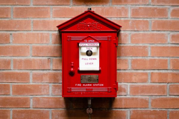 red fire alarm station attached on brick wall red fire alarm station attached on brick wall