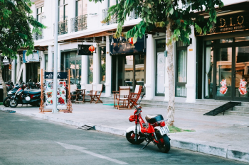 Red Motorcycle Parked Outside Storefront Red Motorcycle Parked Outside Storefront