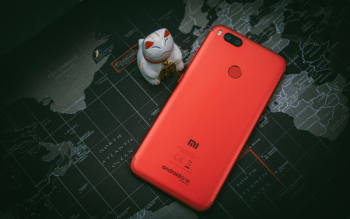 Red Xiaomi Mi Smartphone Beside White Cat Figurine Red Xiaomi Mi Smartphone Beside White Cat Figurine